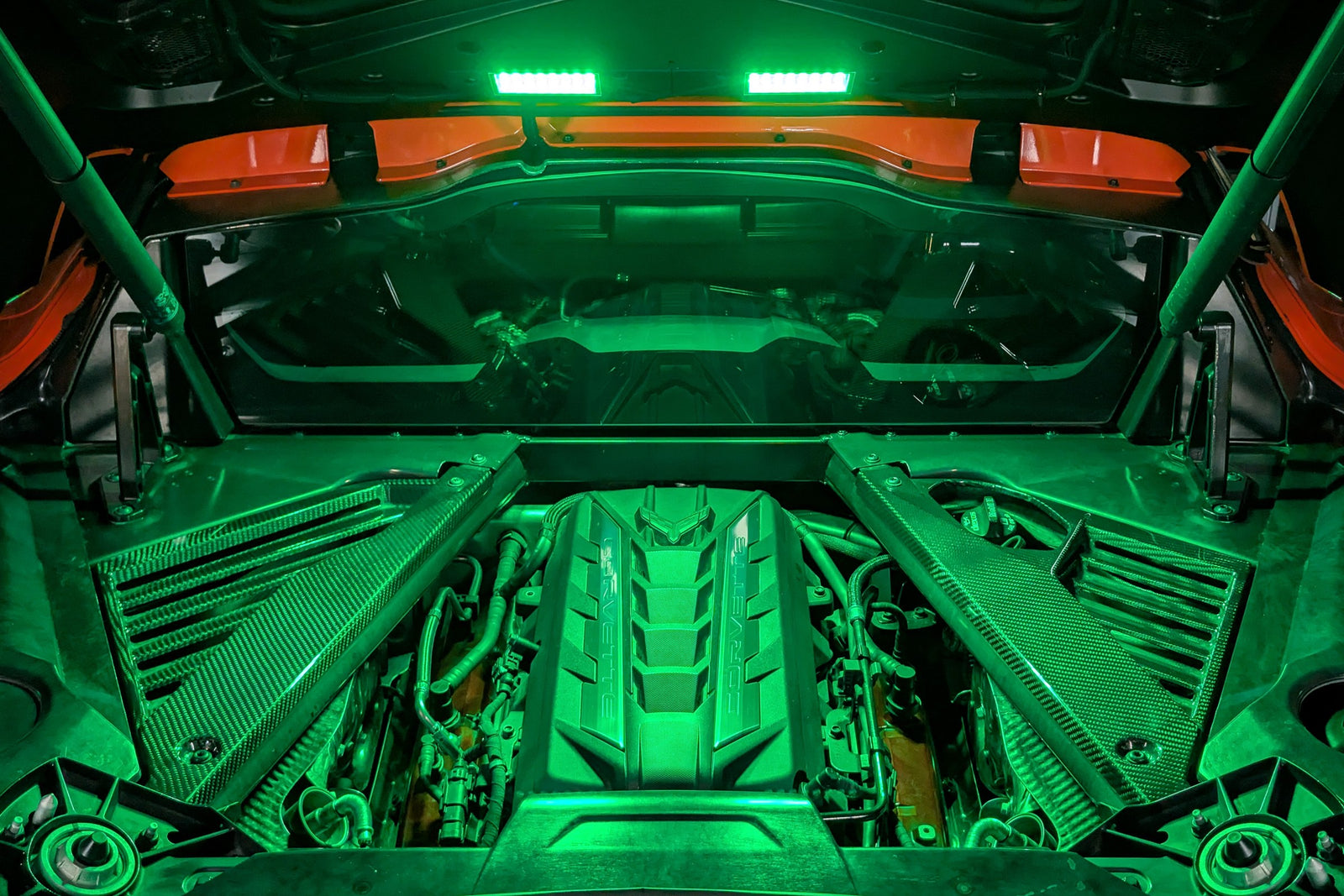 Corvette C8 engine bay lit in green by the Boosted Lighting Solutions Engine Bay Lighting Kit