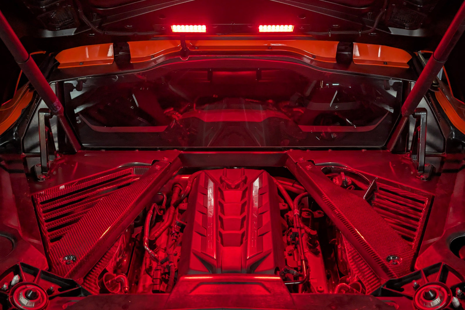 Corvette C8 engine bay lit in red by the Boosted Lighting Solutions Engine Bay Lighting Kit