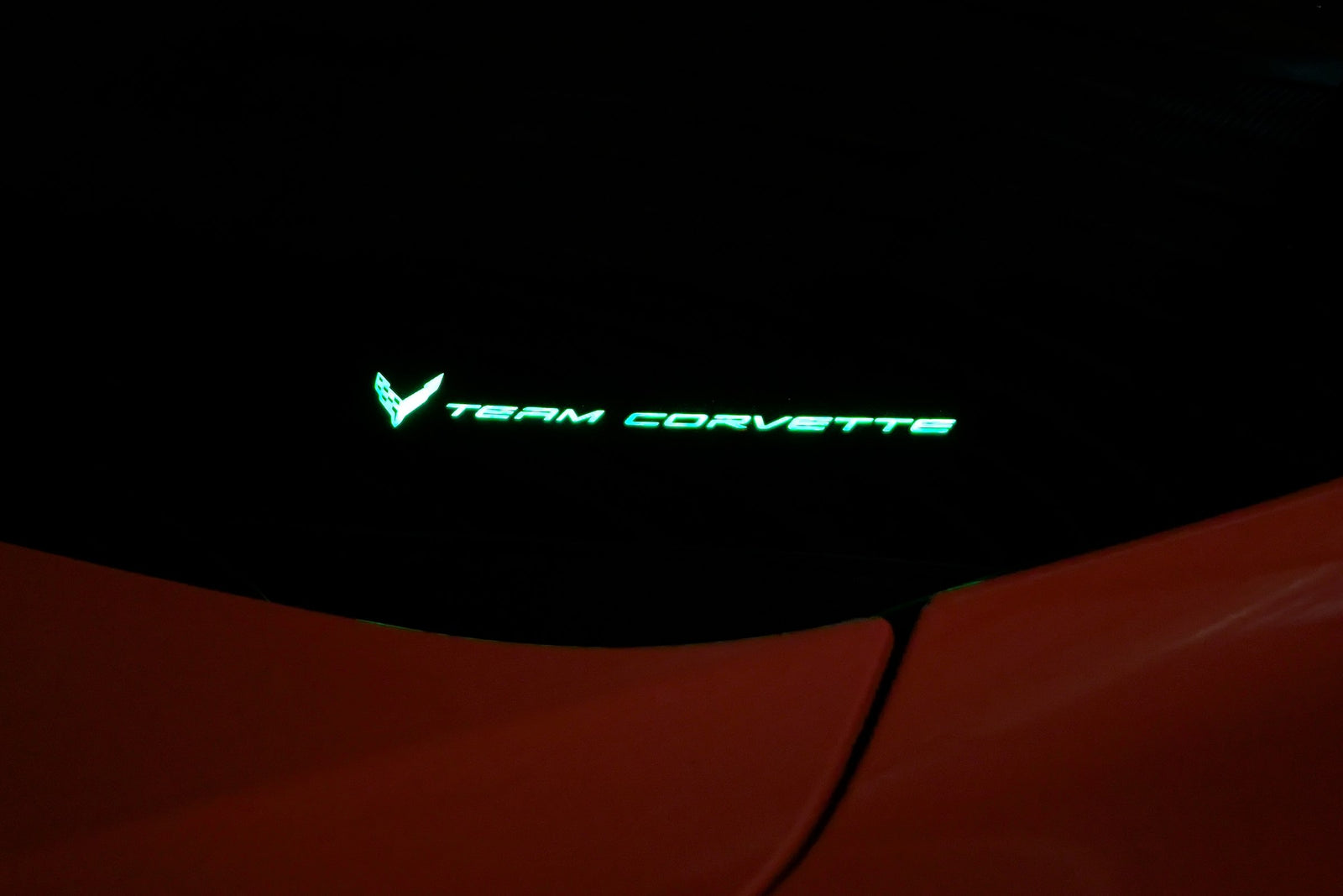 Team Corvette windshield emblem lit in green by the Boosted Lighting Solutions TeamCorvette LED